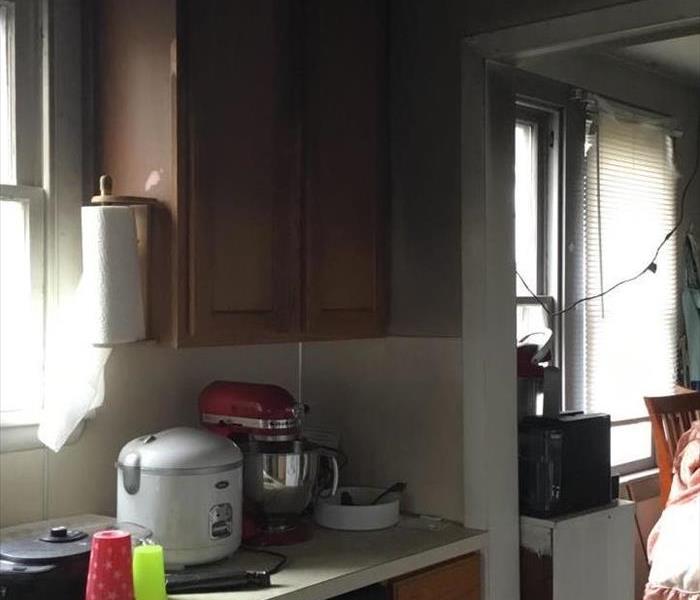 A kitchen with darked walls from a fire