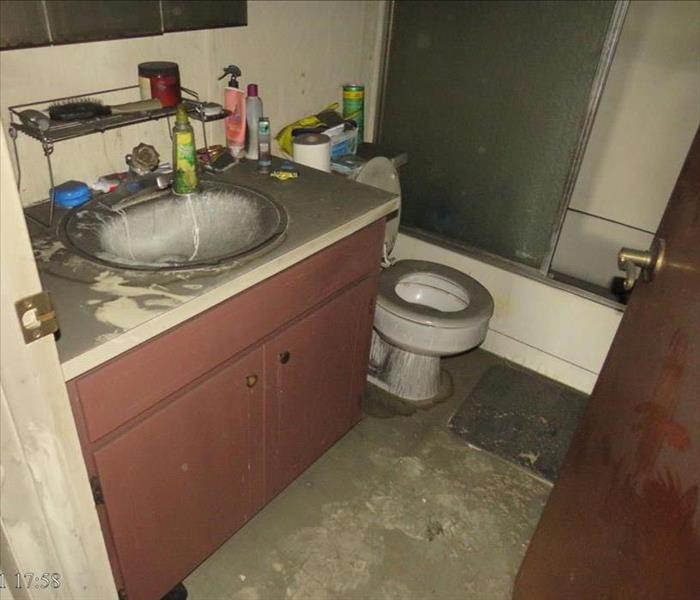 A bathroom with sever soot damage