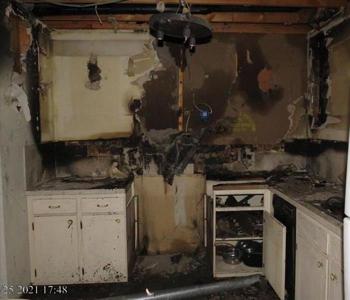 A kitchen with fire damage in a home