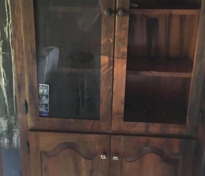 A built in cabinet with soot from a fire