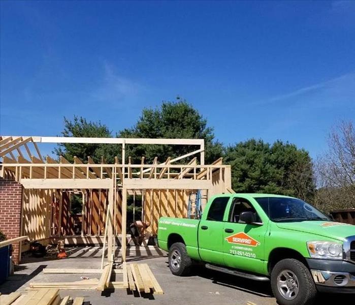 The garage being build with new lumber and a SERVPRO pick up truck