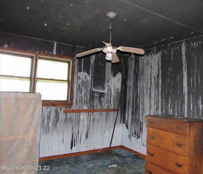 Walls dark with soot almost solid black and carpet. 