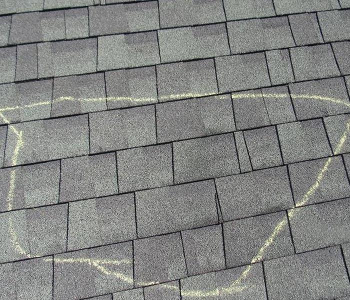 Roof Shingles with a chalk mark to identify damaged area. 